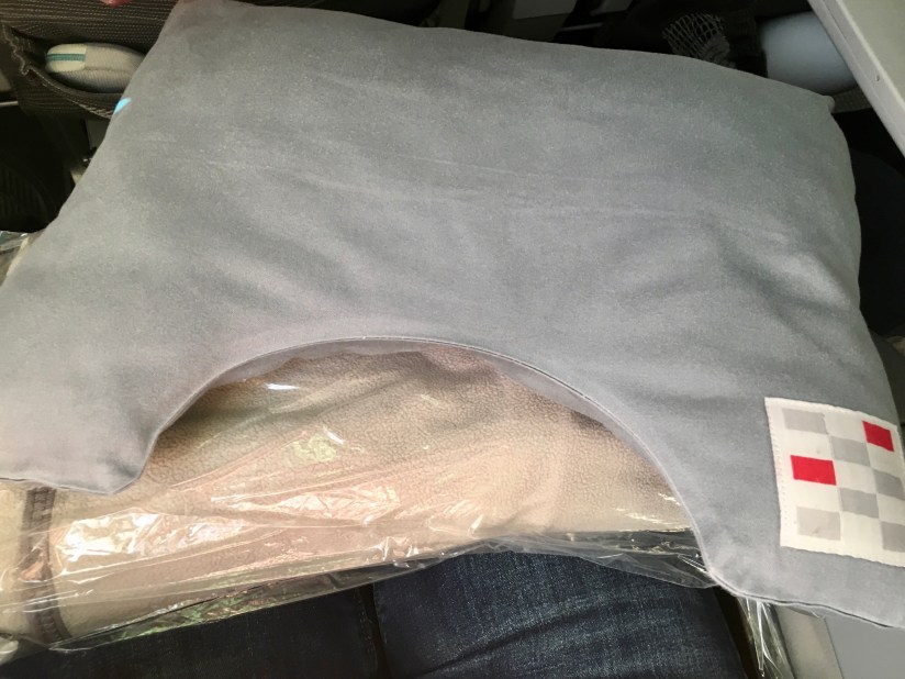 Pillow and blanket provided on JAL flight